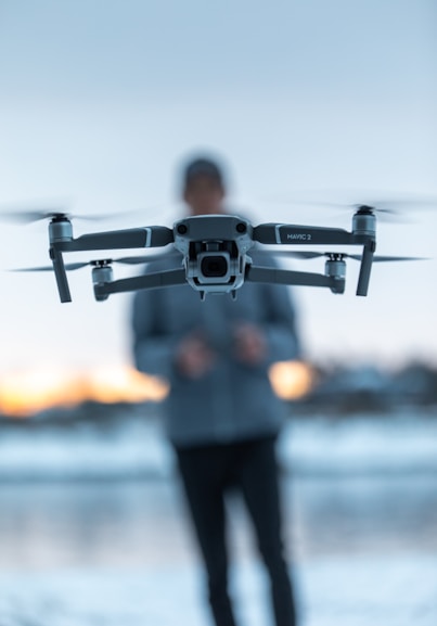 Drone and drone operator facing the camera, in action